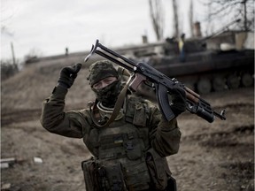 A Ukrainian soldier gestures as he guards territory near Debaltseve, eastern Ukraine on Sunday, Feb. 8, 2015. The Ukrainian government has complained that its forces are outgunned by the separatists, who have deployed advanced Russian weaponry such as rocket launchers and tanks. NATO and Ukraine say Russian soldiers are also fighting in Ukraine.