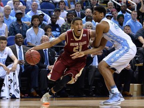 Isaiah Hicks #22 of the North Carolina Tar Heels defends Olivier Hanlan #21 of the Boston College Eagles during a second round game of the ACC basketball tournament at Greensboro Coliseum on March 11, 2015