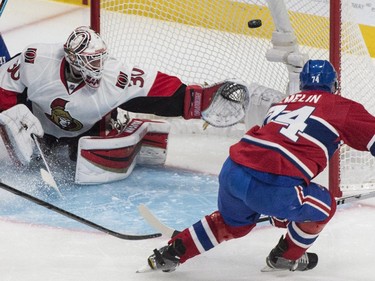 Ottawa Senators goalie Andrew Hammond makes a save off Montreal Canadiens' Alexei Emelin during first period of Game 2 NHL Stanley Cup first round playoff hockey action Friday, April 17, 2015 in Montreal.