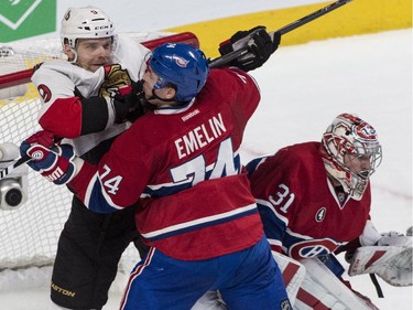 Montreal Canadiens defenseman Alexei Emelin clears out Ottawa Senators' Milan Michalek from in front of goalie Carey Price during first period of Game 2 NHL Stanley Cup first round playoff hockey action Friday, April 17, 2015 in Montreal.
