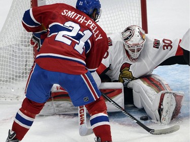 Ottawa Senators goalie Andrew Hammond (30) stops Montreal Canadiens right wing Devante Smith-Pelly (21) during first period of Game 2 NHL first round playoff hockey action Friday, April 17, 2015 in Montreal.