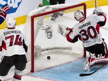 Ottawa Senators goalie Andrew Hammond and Mark Borowiecki look back at the puck in the net on a goal by Montreal Canadiens' Alex Galchenyuk during first period overtime of Game 2 NHL Stanley Cup first round playoff hockey action Friday, April 17, 2015 in Montreal. The Canadiens beat the Senators 3-2 to take a 2-0 lead in the best-of-seven series.