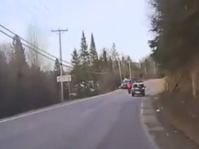 Police are trying to identify this motorcyclist, caught on a police dashcam driving recklessly near Val-des-Monts April 19.