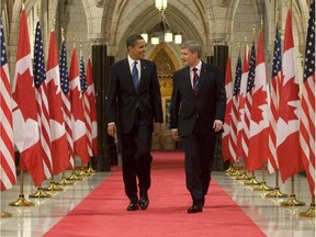 Happier days? U.S. President Barack Obama and Prime Minister Stephen Harper walk down the Hall of Honour in Ottawa, Thursday Feb.19, 2009.