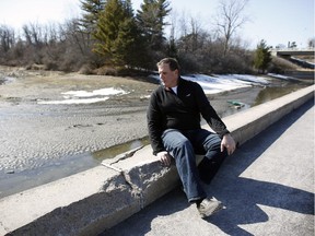 Barry Robinson has been complaining about the safety of the NCC bike path near the Heron Road bridge for 25 years now, ever since his daughter hit the short curb in the area and fell more than eight feet into the riverbed below. Thankfully she was not seriously hurt because the incident happened in the summer when the canal is full with water, unlike the case of an Ottawa man who fell last week. (David Kawai / Ottawa Citizen)