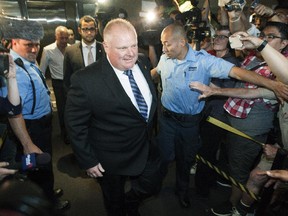 Toronto Mayor Rob Ford enters his office at city hall on his first day back to work after taking part in a rehab program June 30, 2014 in Toronto, Ontario, Canada.