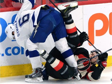 Ottawa Senators' Bobby Ryan gets pushed to the ice by Tampa Bay Lightning Anton Stralman during second period NHL action.