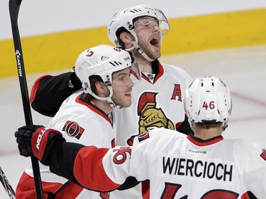 Ottawa Senators right wing Bobby Ryan,top, celebrates with teammates Mike Hoffman and Patrick Wiercioch after scoring the first goal during first period of Game 5 NHL first round playoff hockey action Friday, April 24, 2015 in Montreal.THE CANADIAN PRESS/Ryan Remiorz