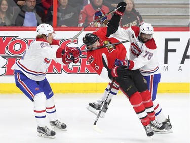 Bobby Ryan of the Ottawa Senators is taken for a ride by P.K. Subban (R) and Jacob De La Rose (L)  of the Montreal Canadiens (no penalty on the play0 during second period action at Canadian Tire Centre in Ottawa, April 19, 2015.