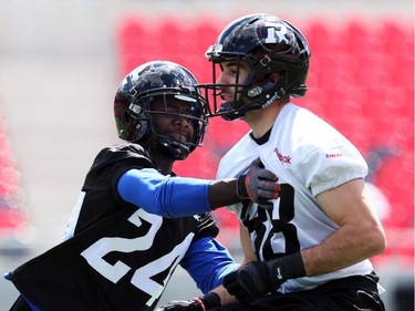 Brad Sinopoli, right, is touched by Jerrell Gavins during practice at TD Place.