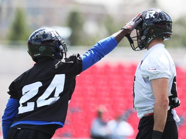 Brad Sinopoli, right, is touched by Jerrell Gavins during practice at TD Place.