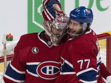 Montreal Canadiens goalie Carey Price and Tom Gilbert celebrate their victory over the Ottawa Senators in Game 1 NHL Stanley Cup first round playoff hockey action Wednesday, April 15, 2015 in Montreal. The Canadiens beat the Senators 4-3 to take a 1-0 lead in the best of seven series.