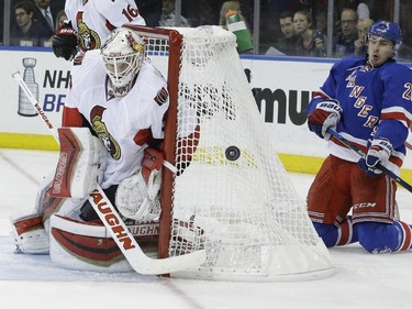 New York Rangers left wing Chris Kreider (20) watches as Ottawa Senators goalie Andrew Hammond (30) defends the net during the second period.