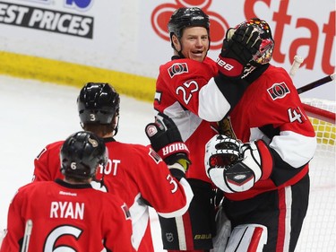 Chris Neil, left, celebrates his team's victory with Craig Anderson.