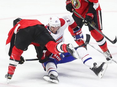 Chris Neil of the Ottawa Senators hits Torrey Mitchell of the Montreal Canadiens during first period action.