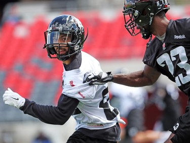 Chris Williams is defended by Roy Finch during practice at TD Place.