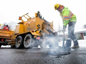 City of Ottawa road crews fill potholes along Southwood Drive in the west end in this file photo.