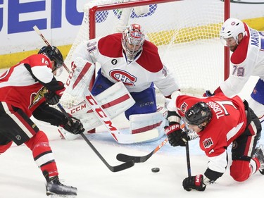 Clarke MacArthur (L) of the Ottawa Senators scores on Carey Price of the Montreal Canadiens during first period action at Canadian Tire Centre in Ottawa, April 19, 2015.