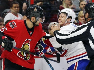 Clarke MacArthur of the Ottawa Senators battles against Brendan Gallagher of the Montreal Canadiens during first period of NHL action at Canadian Tire Centre in Ottawa, April 26, 2015.