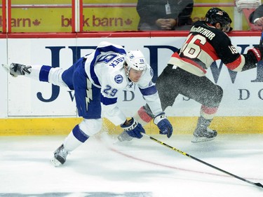 Tampa Bay Lightning Slater Koekkoek, left, gets clipped by Ottawa Senators' Clarke MacArthur during first period NHL action.