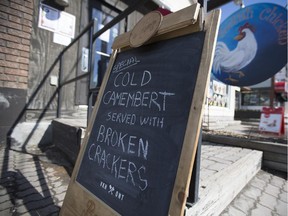 'Cold camembert served with broken crackers' reads the sign outside the Foolish Chicken restaurant in Ottawa April 2. It's a reference to Conservative Sen. Nancy Ruth, who, speaking out Senate meal expenses, said she'd rather not eat crumbly crackers and cheese on airline flights. (Graeme Murphy / Ottawa Citizen)