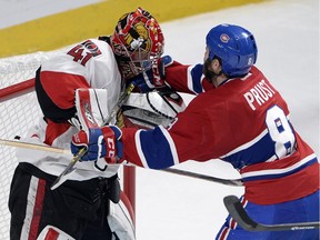 Ottawa Senators goalie Craig Anderson trades cross-checks with Montreal Canadiens right winger Brandon Prust during the third period of Game 5.