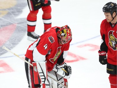 Craig Anderson (L) and Chris Neil of the Ottawa Senators show their dejection after losing to the Montreal Canadiens at Canadian Tire Centre in Ottawa, April 19, 2015.