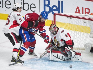 Ottawa Senators goaltender Craig Anderson makes a save on Montreal Canadiens' Lars Eller (81) as Senators' Cody Ceci (5) defends during first period of Game 5 NHL first round playoff hockey action in Montreal, Friday, April 24, 2015.