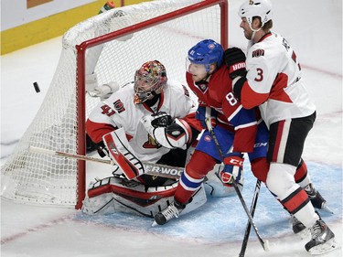 Ottawa Senators goalie Craig Anderson (41) keeps his eyes on the puck as Montreal Canadiens center Lars Eller (81) and Ottawa Senators defenseman Marc Methot (3) battle in front of the net during first period of Game 5 NHL first round playoff hockey action Friday, April 24, 2015 in Montreal.