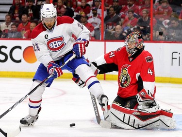 Craig Anderson makes a stop with Devante Smith-Pelly jumping out of the way in the second period as the Montreal Canadiens and the Ottawa Senators play game 3 of the first round playoffs at Canadian Tire Centre.