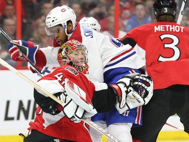 Craig Anderson of the Ottawa Senators battles against Devante Smith-Pelly of the Montreal Canadiens during first period of NHL action at Canadian Tire Centre in Ottawa, April 26, 2015.