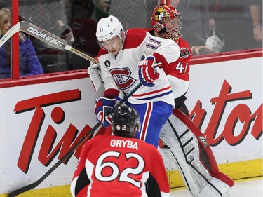 Craig Anderson of the Ottawa Senators gets caught up with Brendan Gallagher of the Montreal Canadiens during second period action.