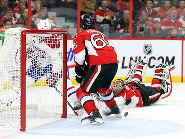 Craig Anderson of the Ottawa Senators lost and edge in the corner and created a golden opportunity for Brandon Prust (L) of the Montreal Canadiens to score as Erik Karlsson defends the open net during first period of NHL action at Canadian Tire Centre in Ottawa, April 26, 2015.