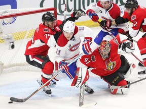 Craig Anderson (R) and Mark Borowiecki (L) of the Ottawa Senators battle Brendan Gallagher of the Montreal Canadiens during second period action of Game 3.