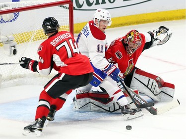 Craig Anderson (R) and Mark Borowiecki (L) of the Ottawa Senators battle Brendan Gallagher of the Montreal Canadiens during second period action at Canadian Tire Centre in Ottawa, April 19, 2015.