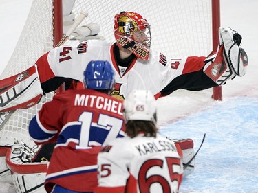 Ottawa Senators goalie Craig Anderson (41) makes a glove save on Montreal Canadiens center Torrey Mitchell (17) duringfirst period of Game 5 NHL first round playoff hockey action Friday, April 24, 2015 in Montreal.