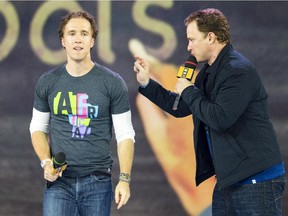 Craig Kielburger, left, and his brother Marc speak during "We Day" in Toronto, on Sept.  20, 2013.