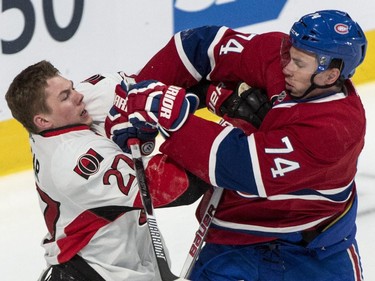 Ottawa Senators' Curtis Lazar fends off Montreal Canadiens' Alexei Emelin (74) during first period of Game 2 NHL Stanley Cup first round playoff hockey action Friday, April 17, 2015 in Montreal.