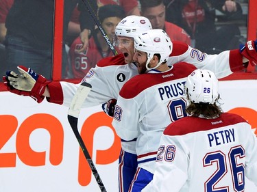 Montreal Canadiens' Dale Weise (22), Brandon Prust (8) and Jeff Petry celebrate Weise's game-winning goal against the Ottawa Senators in sudden death overtime of game 3 of first round Stanley Cup NHL playoff hockey action in Ottawa on Sunday, April 19, 2015. The Canadiens defeated the Senators 2-1.