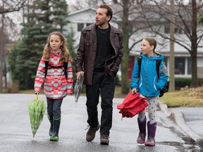 Dan Rubinstein, author of the book Born to Walk, walked all over the world researching his book. But he was struck by a car while walking his children, Daisy, (L) and Maggie, (R), both 10, to school in his Alta Vista neighbourhood. Assignment - 120364 Photo taken at 08:25 on April 21. (Wayne Cuddington / Ottawa Citizen)