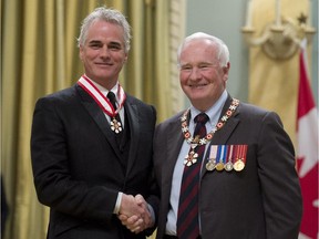 Governor General David Johnston invests actor and director Paul Gross as an Officer of the Order of Canada during a ceremony at Rideau Hall in Ottawa on Friday, February 13, 2015.