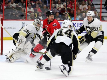 David Legwand is surrounded by Penguin players Marc-Andre Fleury, left, Taylor Chorney, centre, and Derrick Pouliot, right, in the first period.