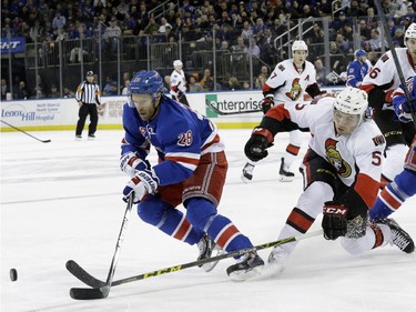 New York Rangers center Dominic Moore (28) battles for the puck against Ottawa Senators defenseman Cody Ceci (5) during the second period.