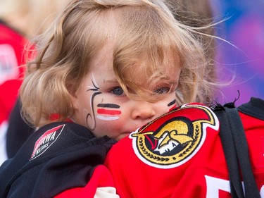 Emma Munhall, 2, clings to her mom in the Fan Zone as the Ottawa Senators take on the Montreal Canadiens at the Canadian Tire Centre in Ottawa for Game 6 of the NHL Eastern Conference playoffs on Sunday evening.