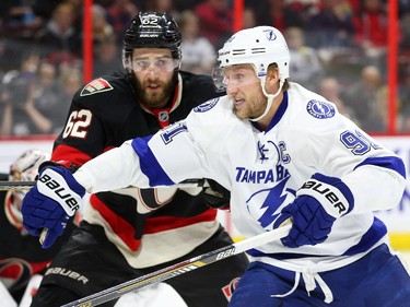 Eric Gryba of the Ottawa Senators defends against Steven Stamkos of the Tampa Bay Lightning during second period NHL action.