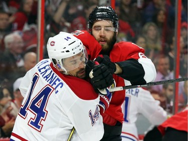 Eric Gryba of the Ottawa Senators hits Tomas Plekanec of the Montreal Canadiens during first period of NHL action at Canadian Tire Centre in Ottawa, April 26, 2015.