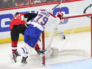 Erik Condra of the Ottawa Senators is hit by Andrei Markov of the Montreal Canadiens during first period action.