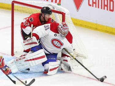 Erik Condra of the Ottawa Senators tries to steal the puck from Carey Price of the Montreal Canadiens during second period action at Canadian Tire Centre in Ottawa, April 19, 2015.