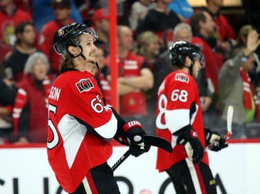Erik Karlsson and Mike Hoffman (R) of the Ottawa Senators show their dejection after losing their series against the Montreal Canadiens during third period of NHL action at Canadian Tire Centre in Ottawa, April 26, 2015.