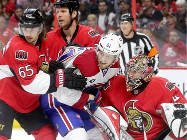 Erik Karlsson (L) and Marc Methot stay in tight on Lars Eller (C) who's crowding Craig Anderson (R) in the second period as the Ottawa Senators take on the Montreal Canadiens at the Canadian Tire Centre in Ottawa for Game 6 of the NHL Eastern Conference playoffs on Sunday evening.